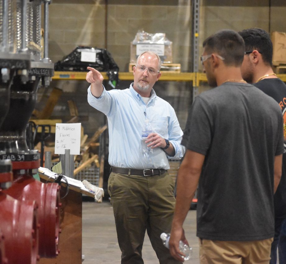 Group of employees in facility, wearing protection goggles