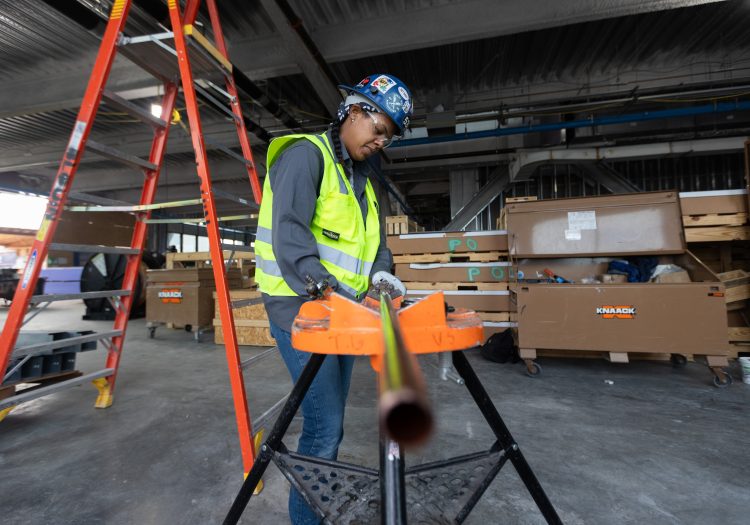 Woman in construction gear, working on a project