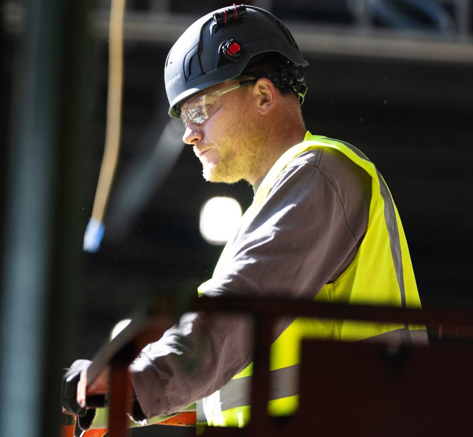 Man in hard hat and vest, on construction site